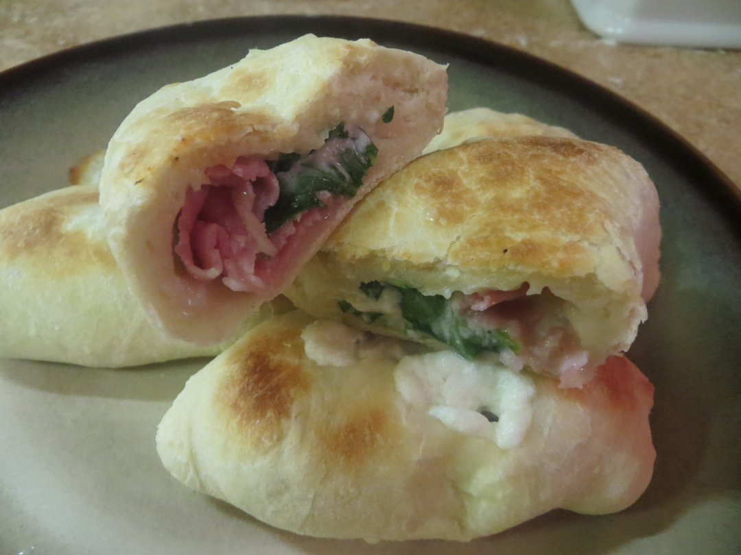 Gourmet calzone stuffed with prosciutto, goat cheese and arugula.