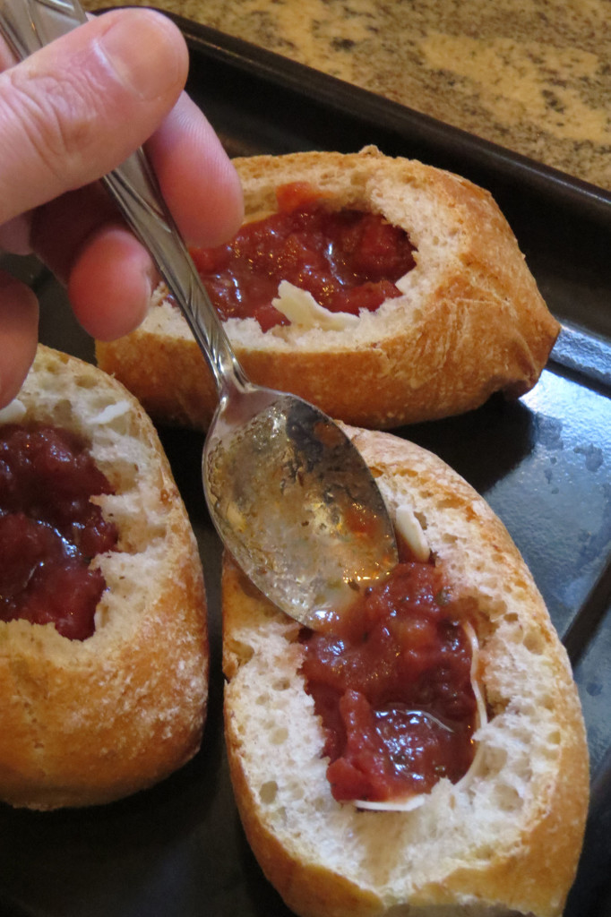 Line the rolls with sliced provolone cheese, then with a teaspoon of bruschetta (home made or store bought).